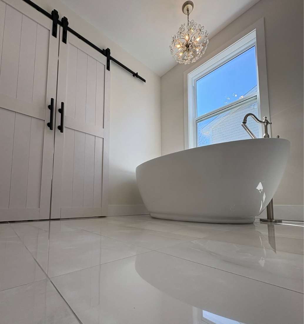 The Albany Project — a heritage St. John's bathroom reshaped with a freestanding soaking tub, heated floors, and barn-door privacy.