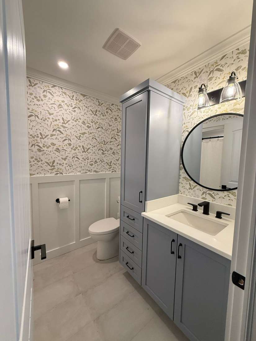 The finished Glenlonan Main bathroom — floral wallpaper and blue-gray cabinetry.