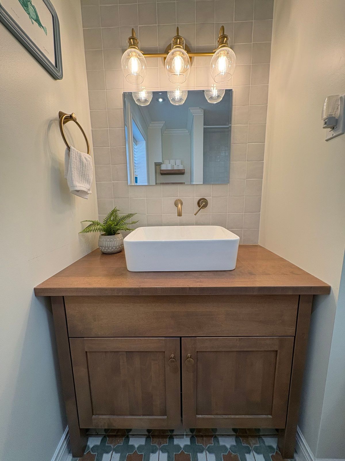 New Cove vanity with vessel sink and brass faucet.
