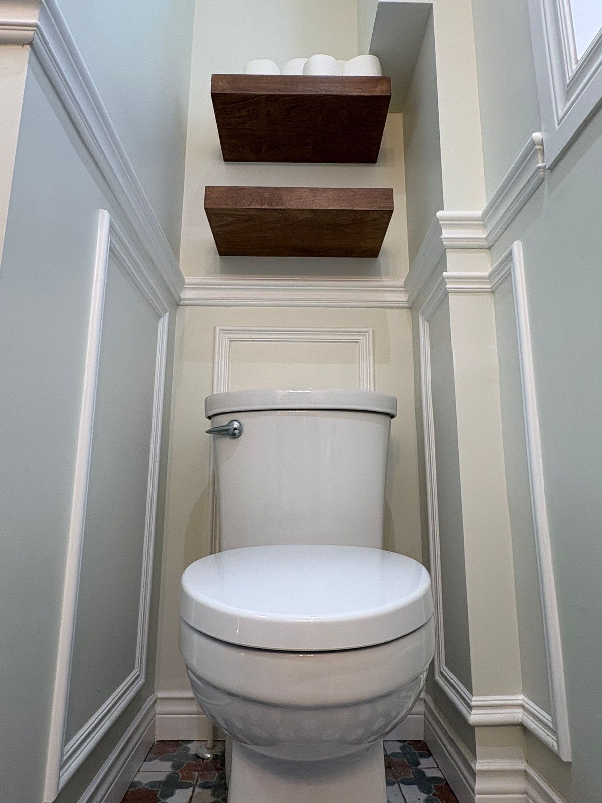 New Cove toilet nook with floating wood shelves.