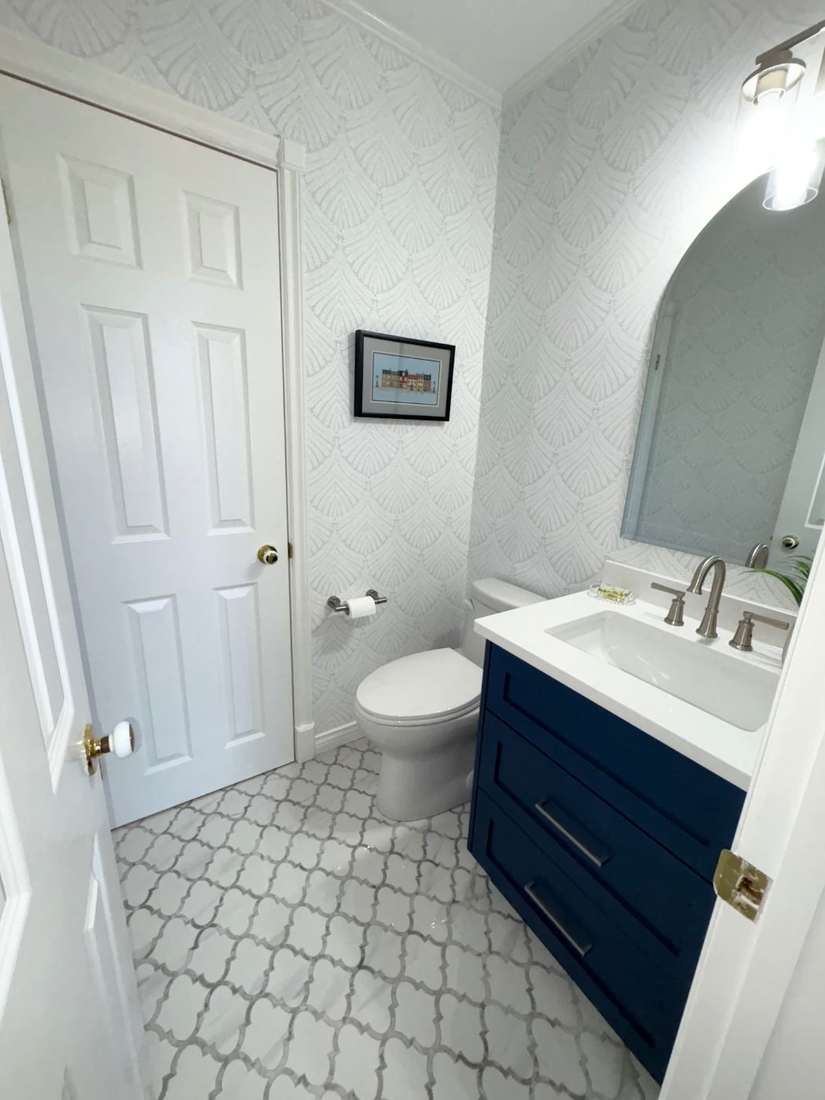 Kensington powder room — finished interior with framed artwork.