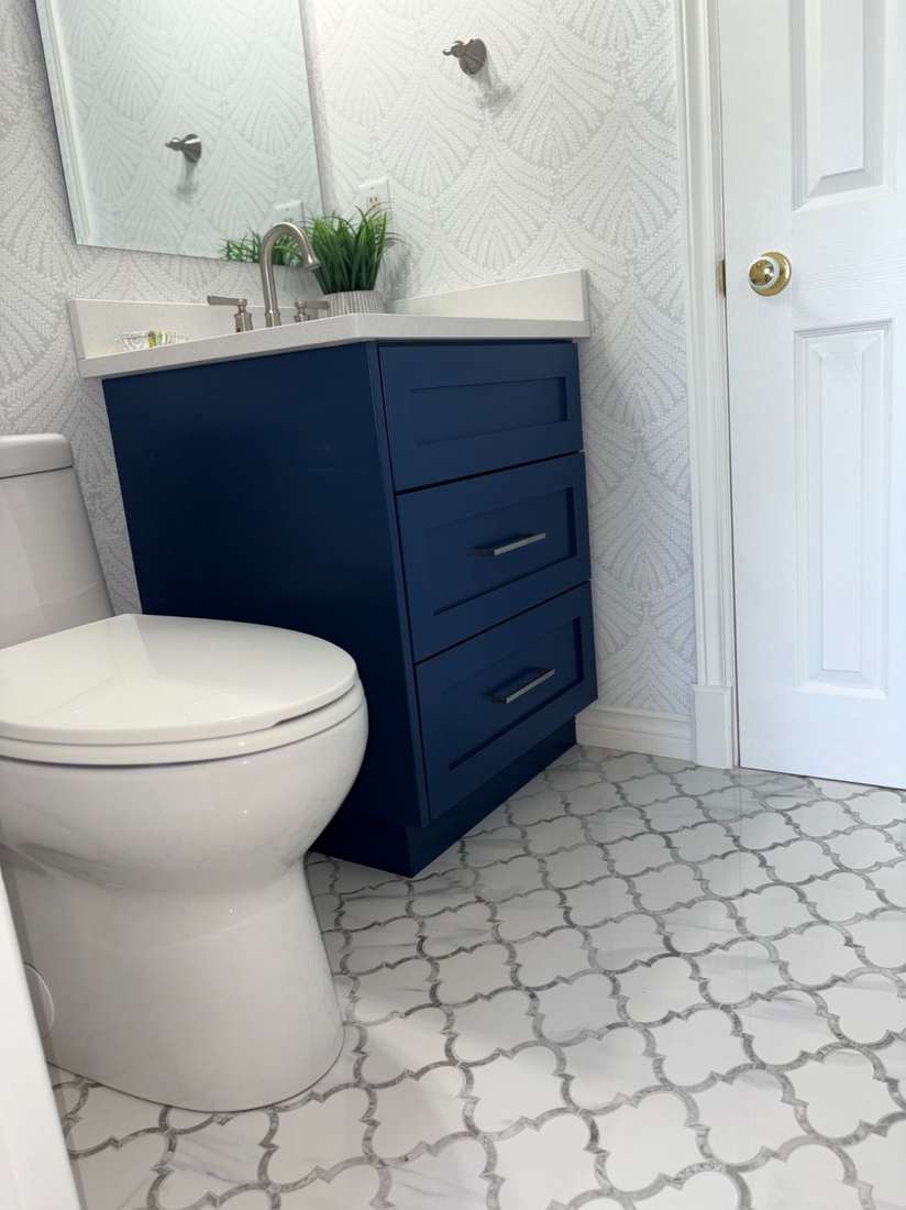 Kensington powder room — navy vanity and quartz countertop.