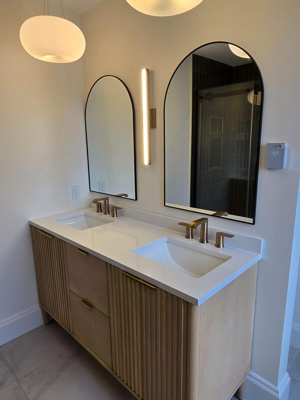 Newtown Road — arched mirrors and fluted oak cabinetry, full view.