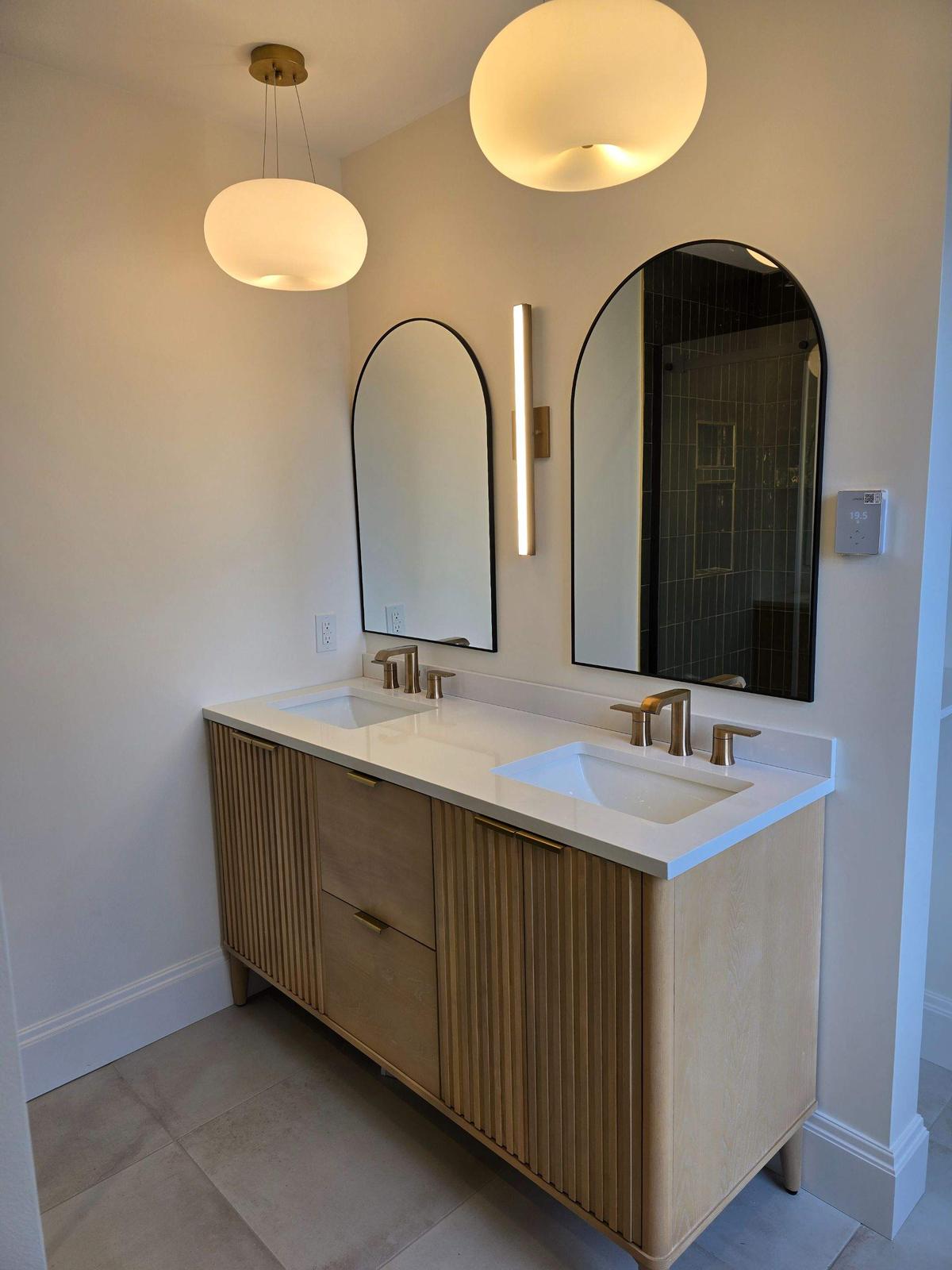 Newtown Road — the finished vanity beneath pendant lighting.
