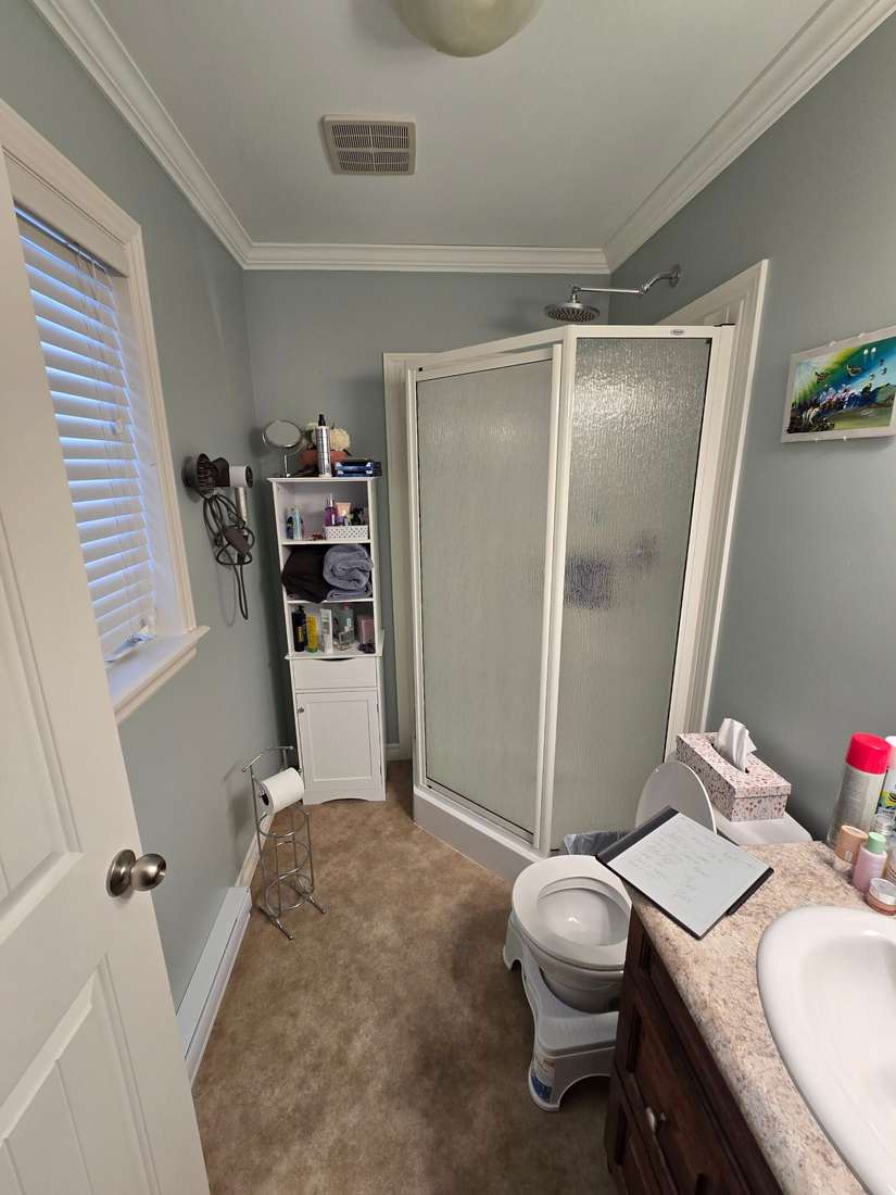 Glenlonan ensuite bathroom before renovation — corner shower and original finishes.