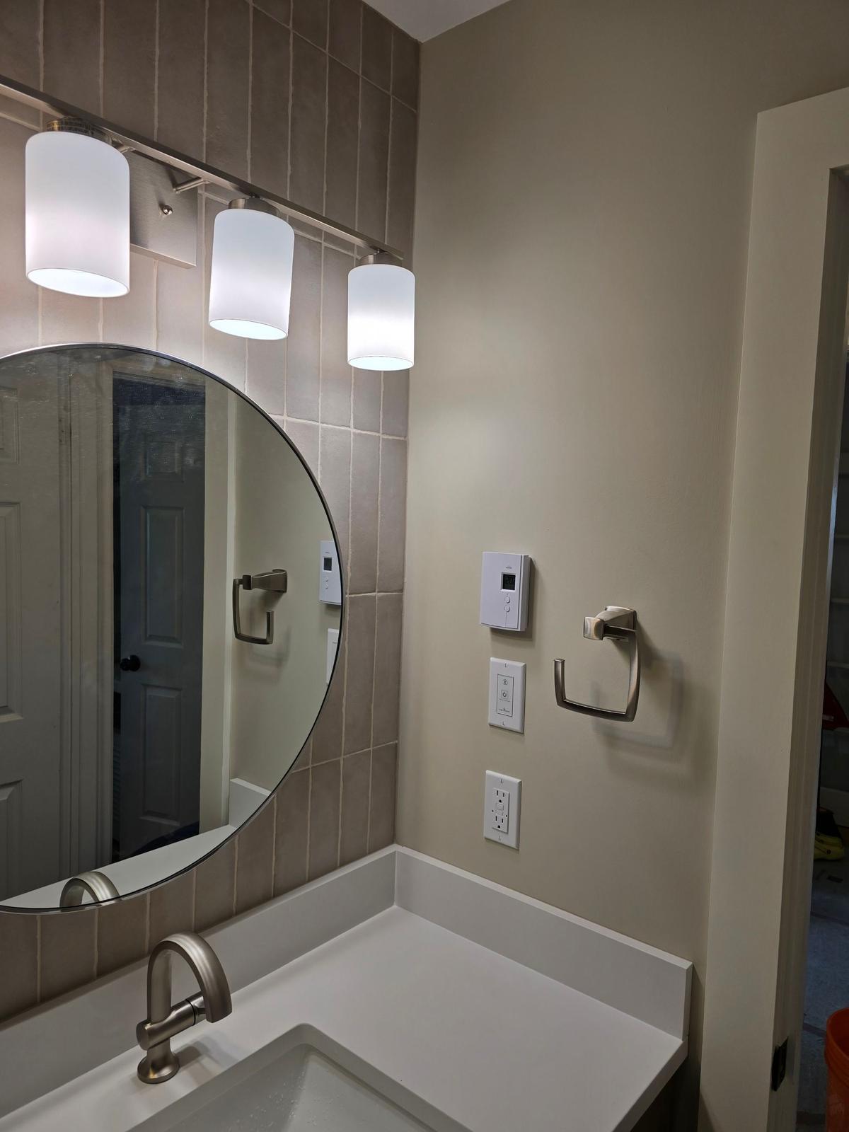 Ranger Avenue — finished vanity and round mirror.